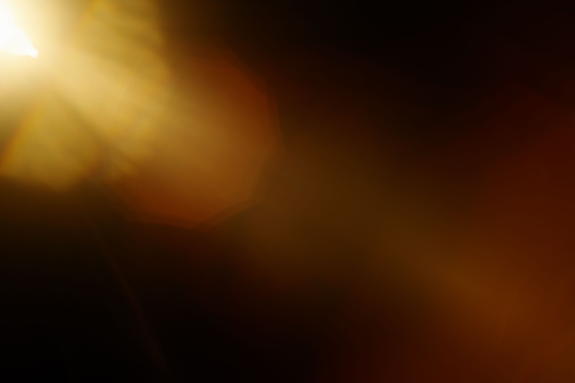 Dreamy real lens flare with organic imperfections on dark background