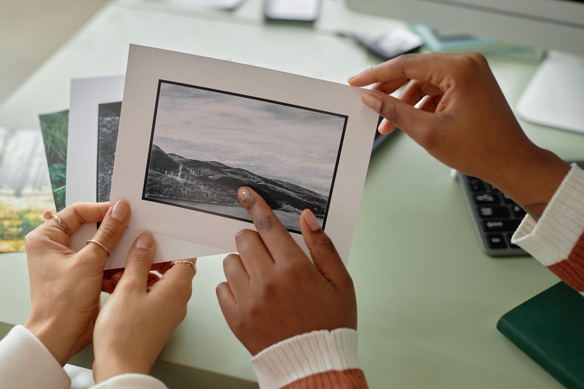 Close Up of Two Women Holding Photo Prints
