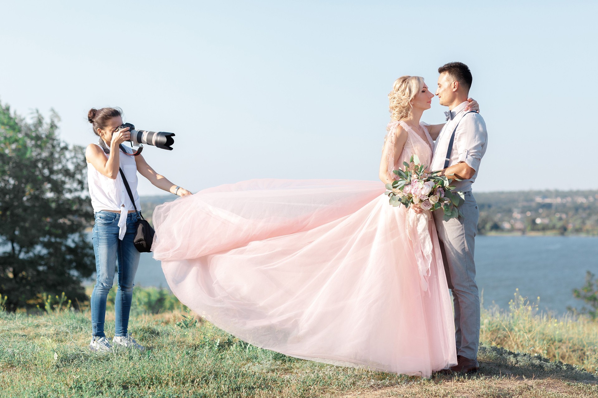 wedding photographer takes pictures of bride and groom