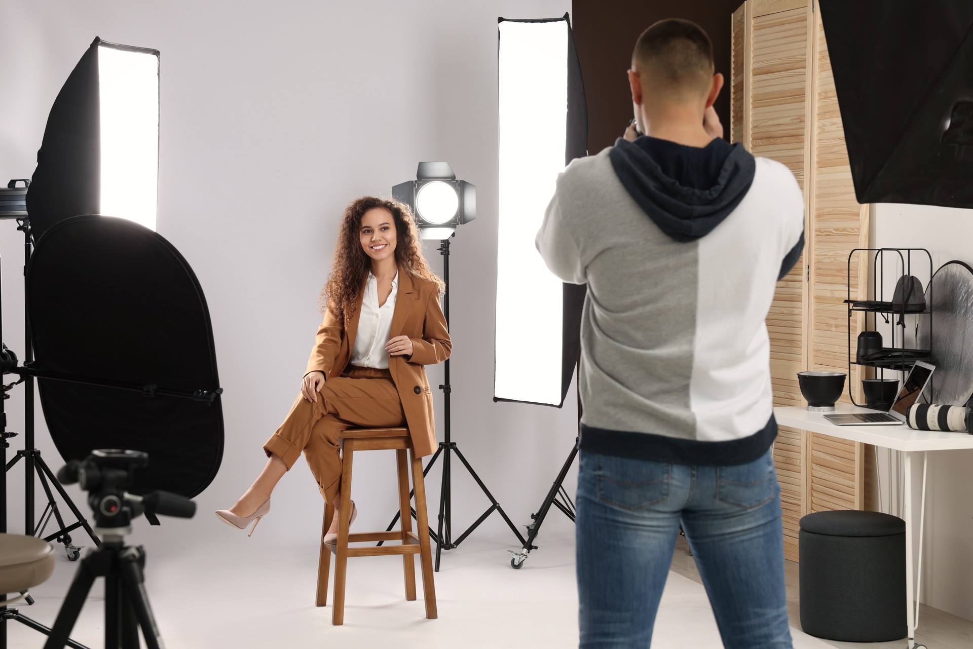 Beautiful African American model posing for professional photographer in studio